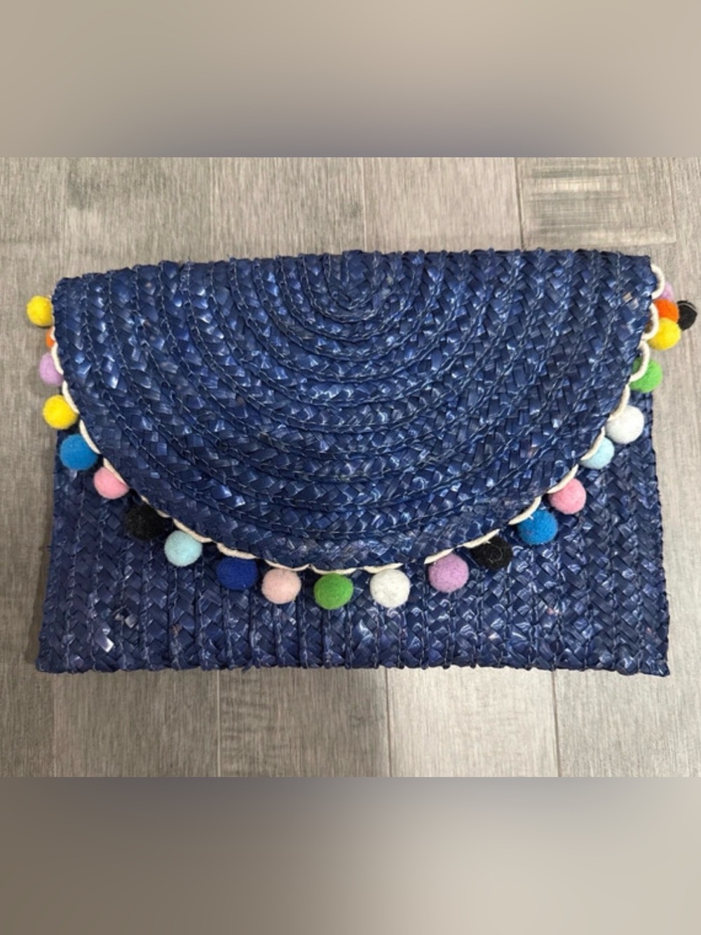 Francesca’s Blue Woven Clutch with Multicolored Pom Poms
